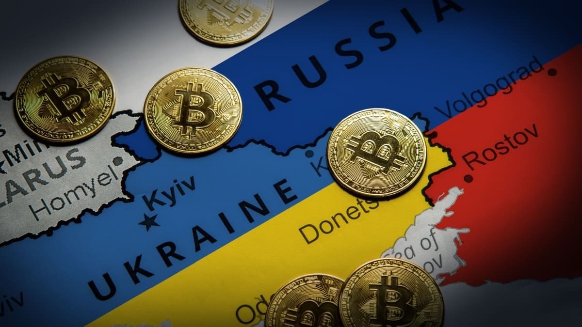 Ein Bild von einer Landkarte mit Russland und der Ukraine, dazwischen sind Bitcoin-Münzen verteilt.