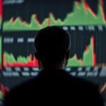 Een afbeelding van een handelaar die naar een scherm vol met trades kijkt op een beurs